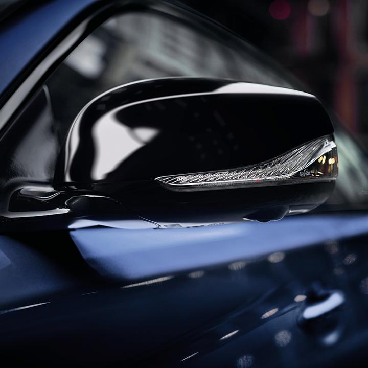 Close-up view of the side mirror on a blue INFINITI Q50. Close-up view of the side mirror on a blue INFINITI Q50.