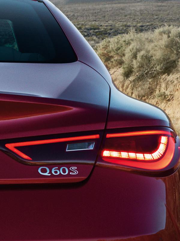 Close-up view of the taillight of a red INFINITI Q60. Close-up view of the taillight of a red INFINITI Q60.