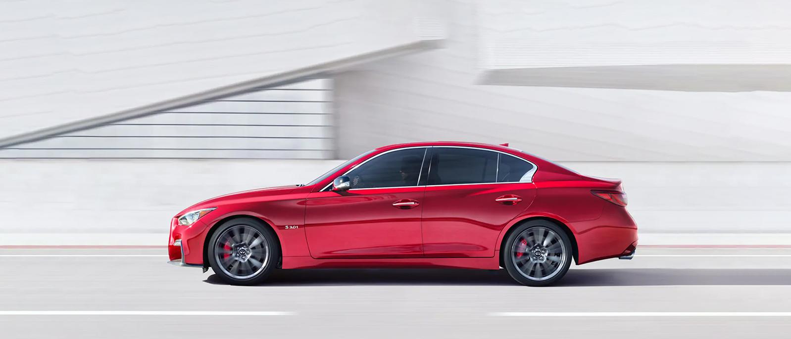 A Red INFINITI Q50 Riding on a Bridge A Red INFINITI Q50 Riding on a Bridge