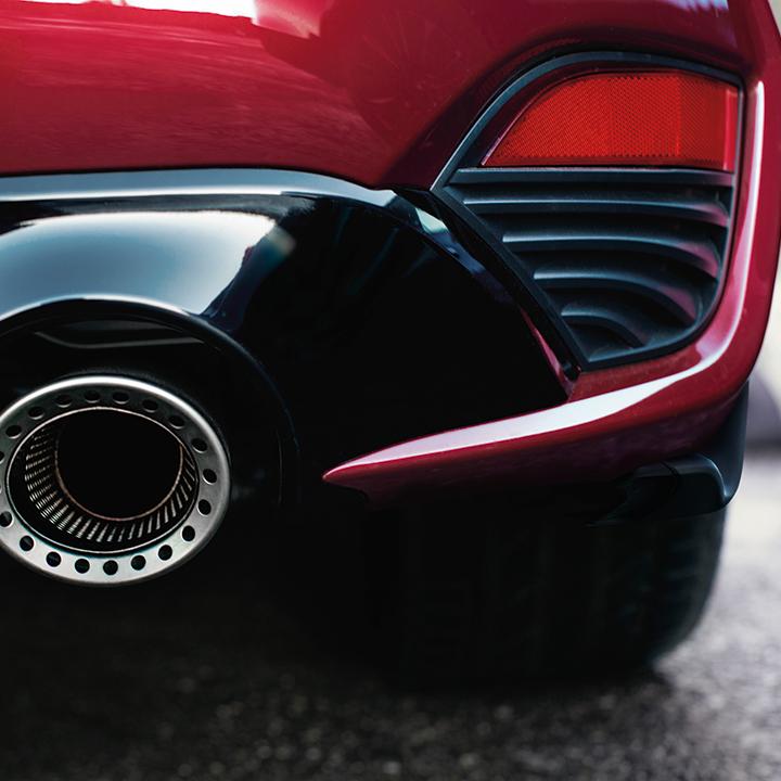 Close-up view of the exhaust port on a red INFINITI Q60. Close-up view of the exhaust port on a red INFINITI Q60.