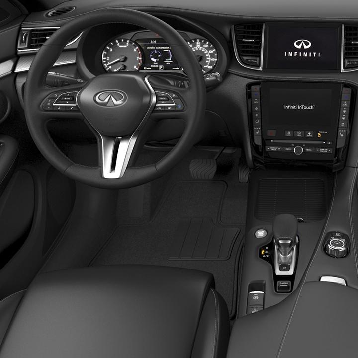 Interior view of a grey INFINITI QX50 from a driver's point-of-view. Interior view of a grey INFINITI QX50 from a driver's point-of-view.