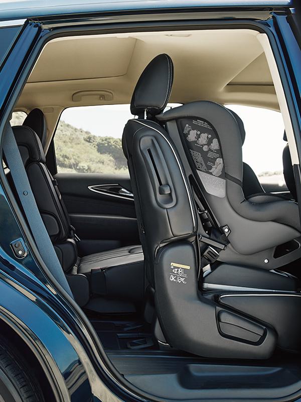 Close-up of a blue INFINITI QX60 with the rear door open showing a car seat installed. Close-up of a blue INFINITI QX60 with the rear door open showing a car seat installed.