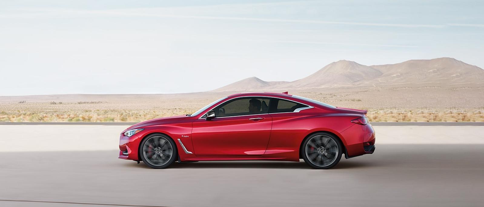 A Red INFINITI Q60 Riding on a Mountain Highway. A Red INFINITI Q60 Riding on a Mountain Highway.