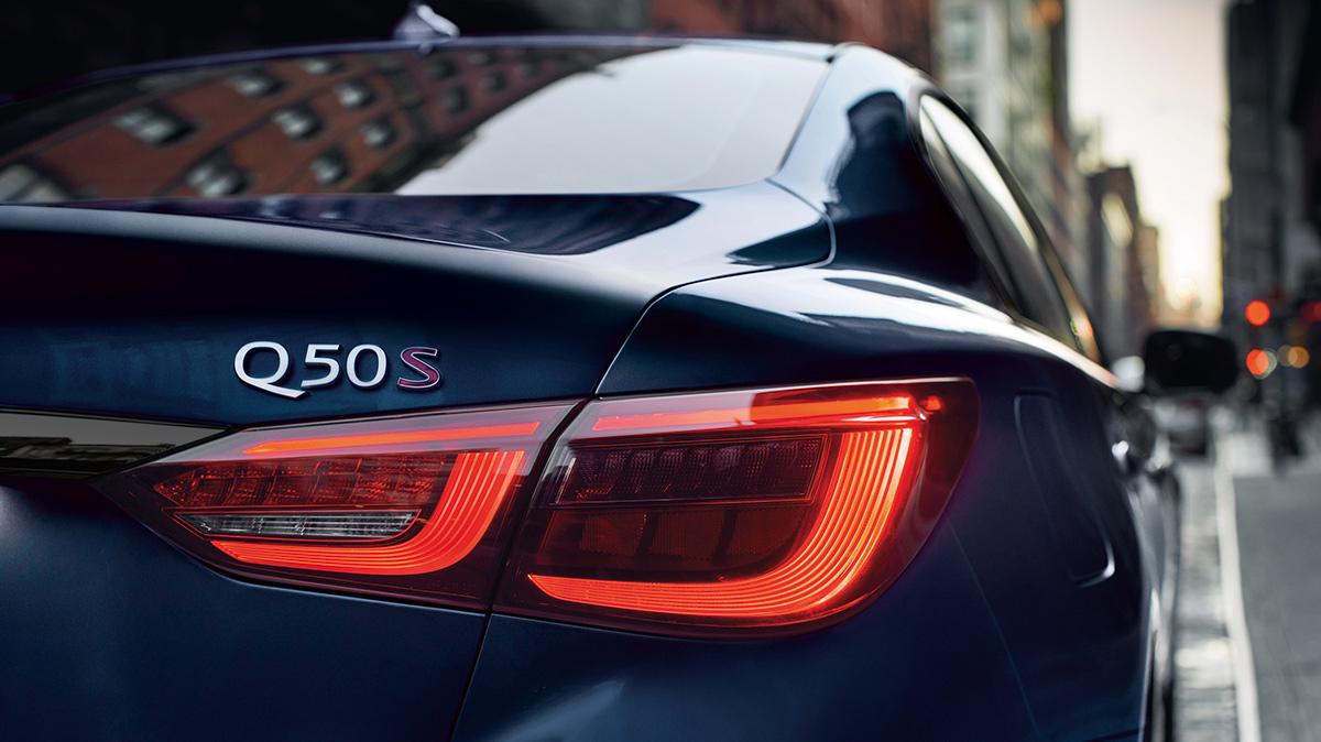 Close-up view of the taillight of a blue Q50 in the city. Close-up view of the taillight of a blue Q50 in the city.