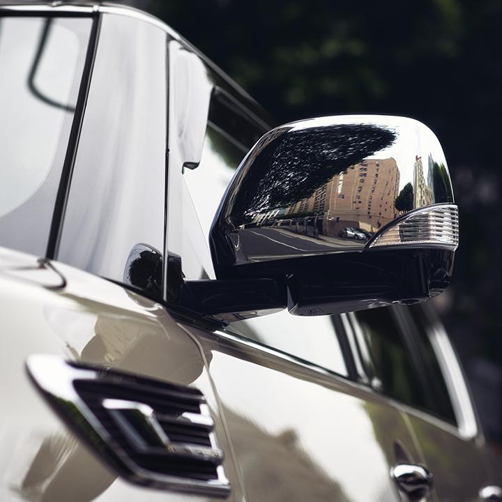 Close-up view of an INFINITI QX80 side mirror. Close-up view of an INFINITI QX80 side mirror.