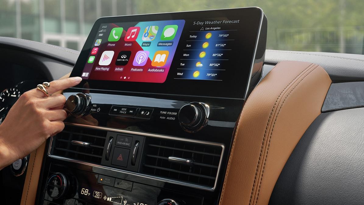 Front dash touch screen featuring Apple CarPlay on an INFINITI QX80.