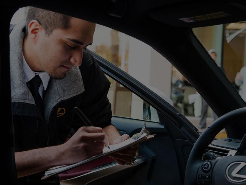 Salesman inspecting Lexus interior