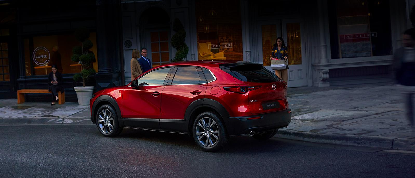 A Red 2020 Mazda CX-30 parked in front of a coffee shop. A Red 2020 Mazda CX-30 parked in front of a coffee shop.