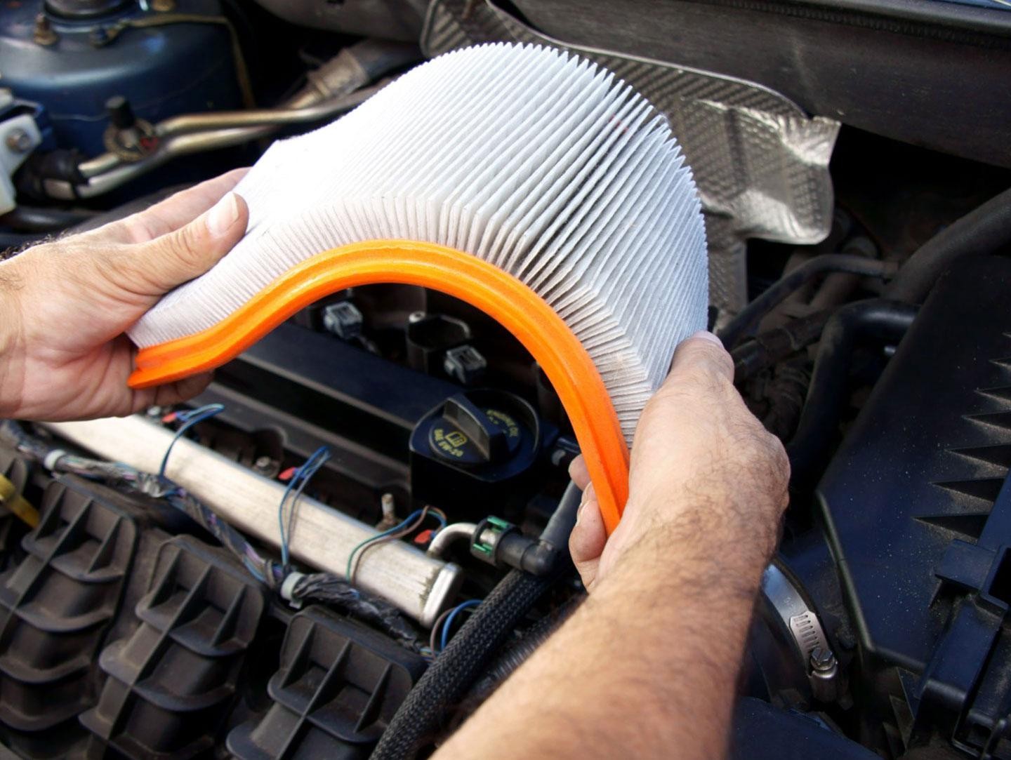 technician looking at air filter