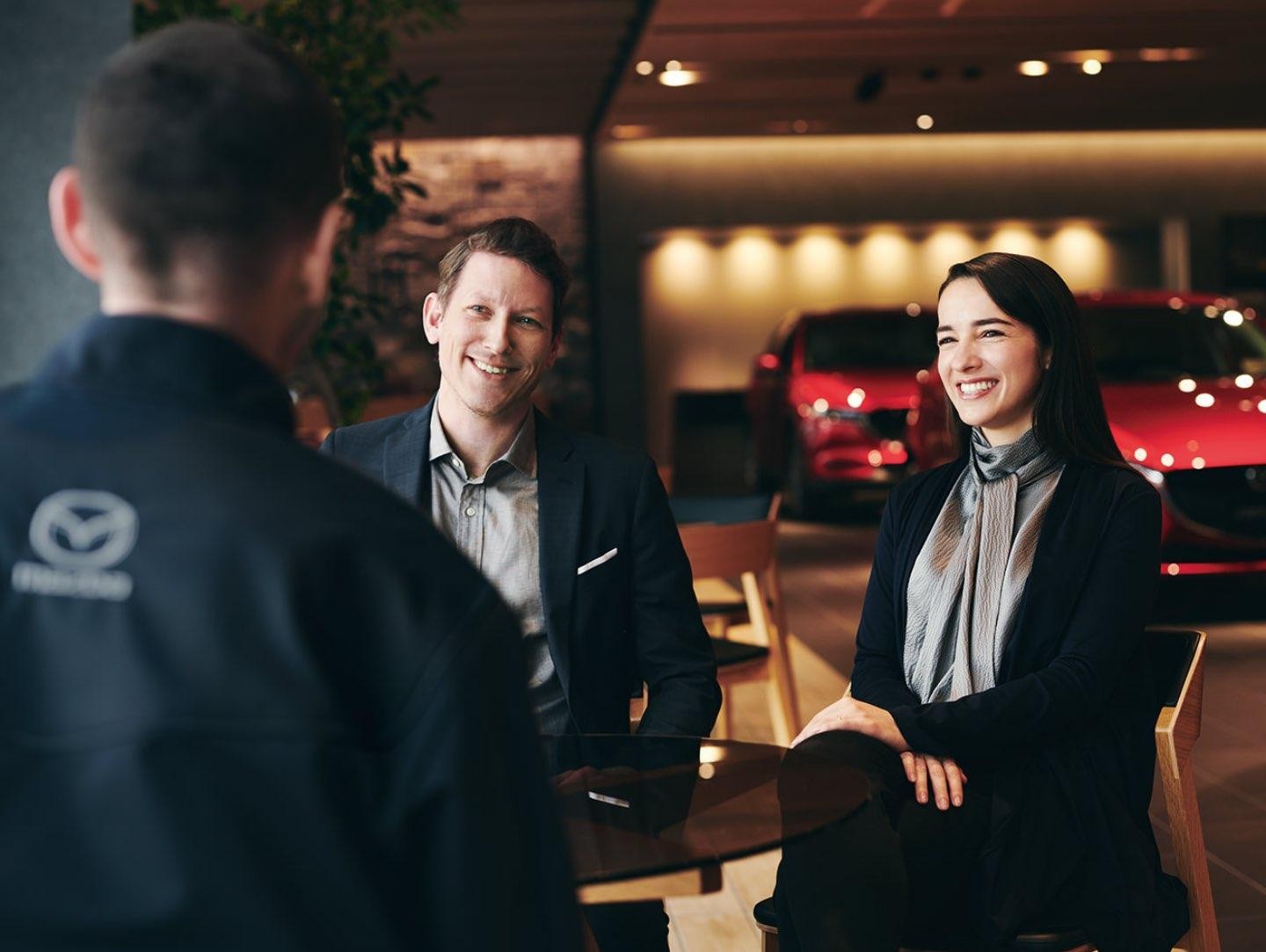 Sitting Customers Smiling at Service Technician