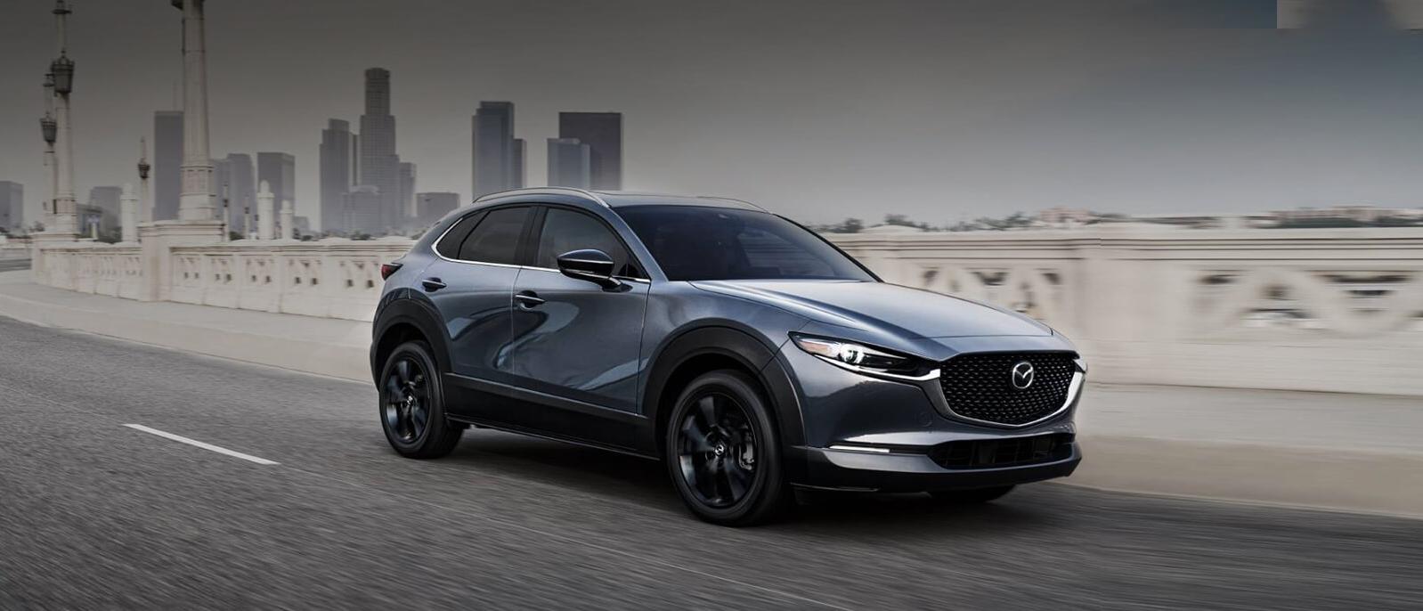 A 2022 Mazda CX-30 riding on a city highway. A 2022 Mazda CX-30 riding on a city highway.