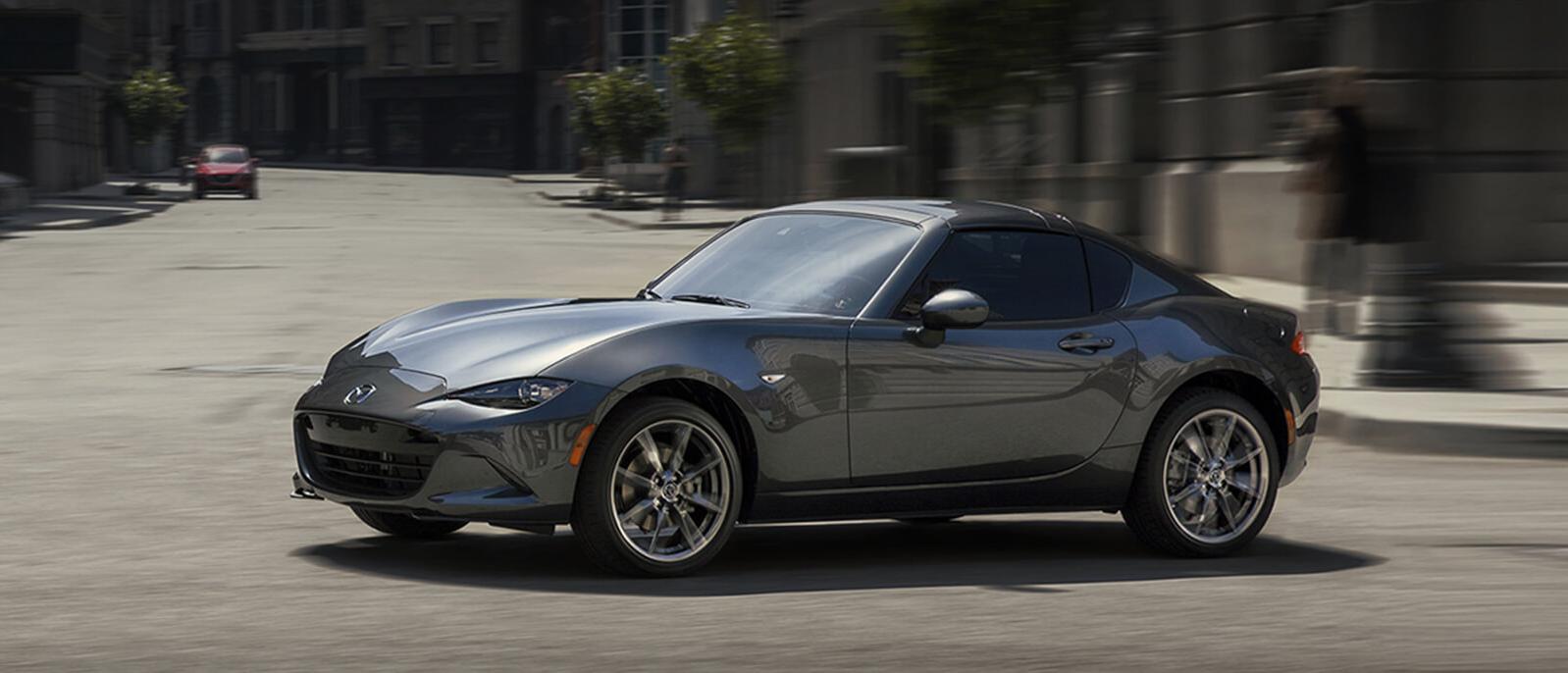 A 2021 MX-5_Miata_RF is cruising through city road A 2021 MX-5_Miata_RF is cruising through city road