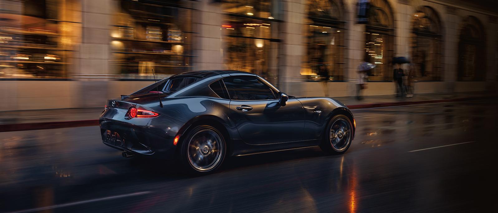 A 2020 MX-5_Miata_RF is cruising through city road A 2020 MX-5_Miata_RF is cruising through city road