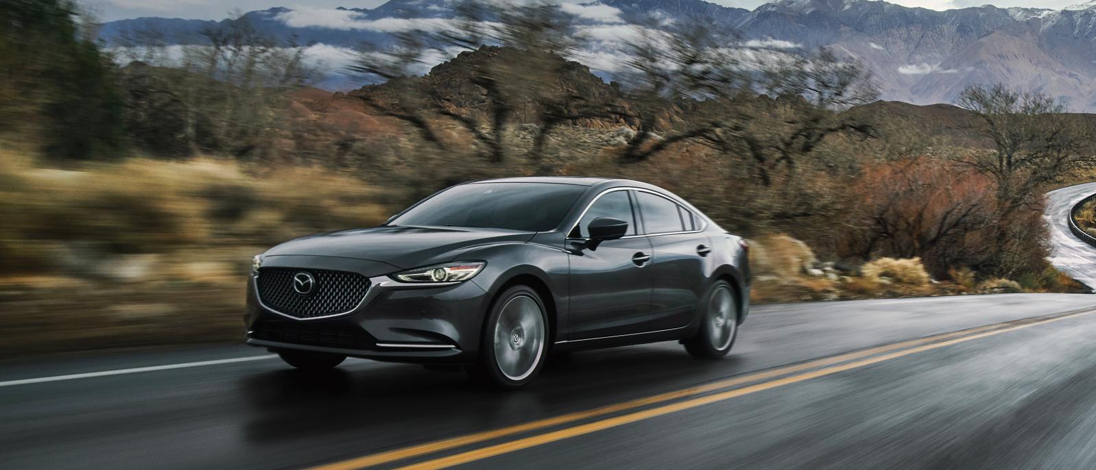 A 2020 Mazda6 is cruising through a mountain highway A 2020 Mazda6 is cruising through a mountain highway