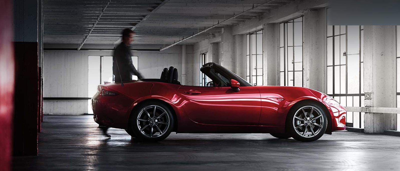 A 2022 Mazda MX-5 Miata parked in a building. A 2022 Mazda MX-5 Miata parked in a building.