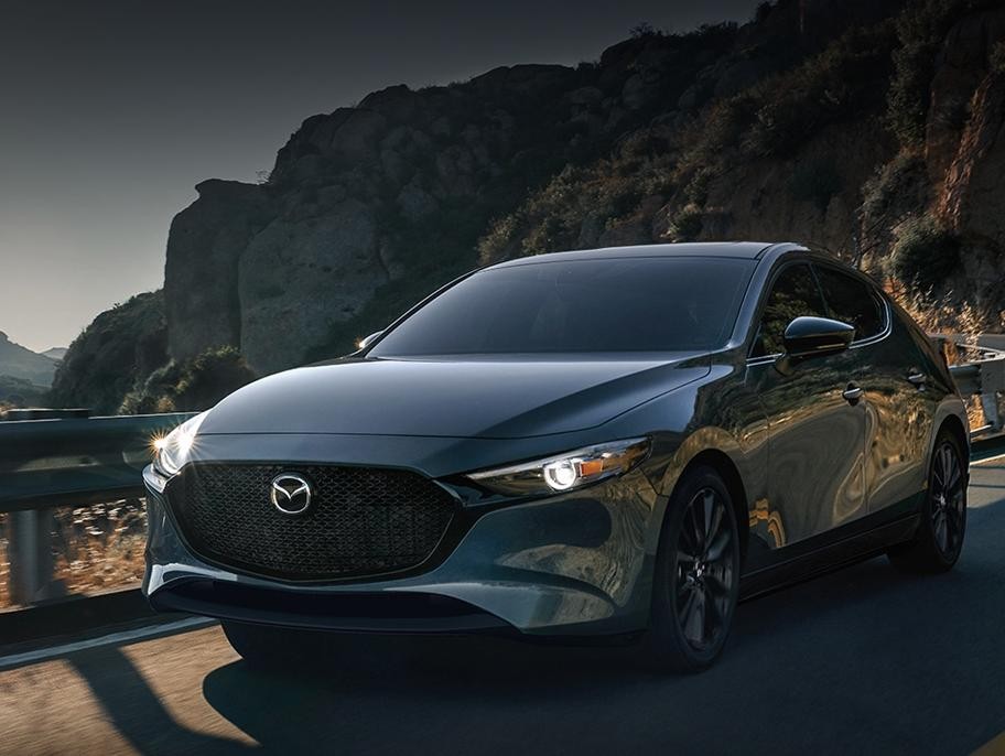A 2022 Mazda3 Hatchback driving on the road.