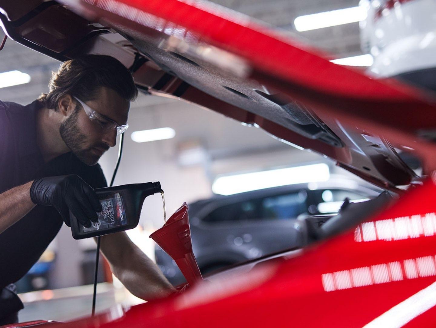 Technician Pouring Oil