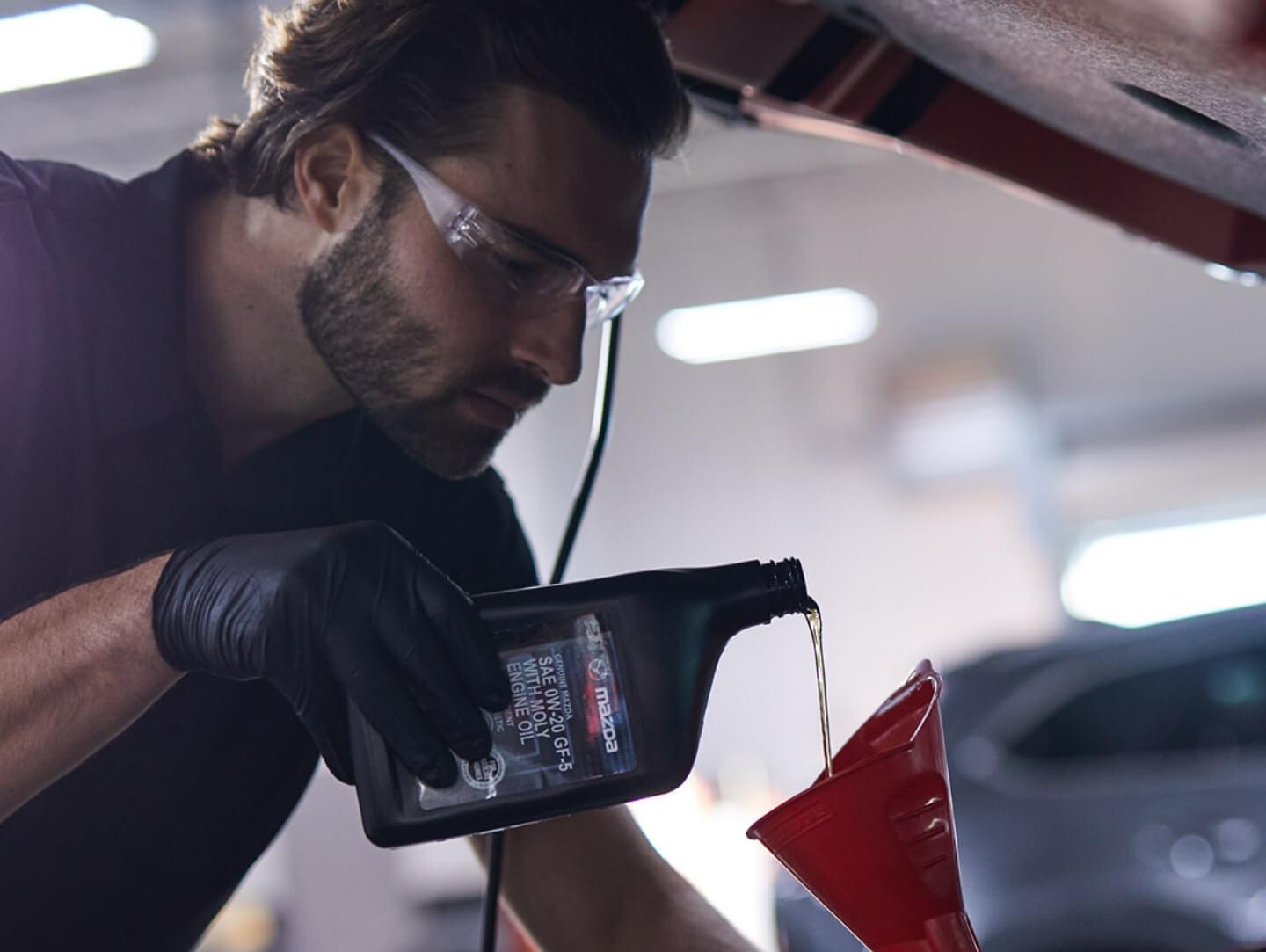 Service Technician Pouring Oil