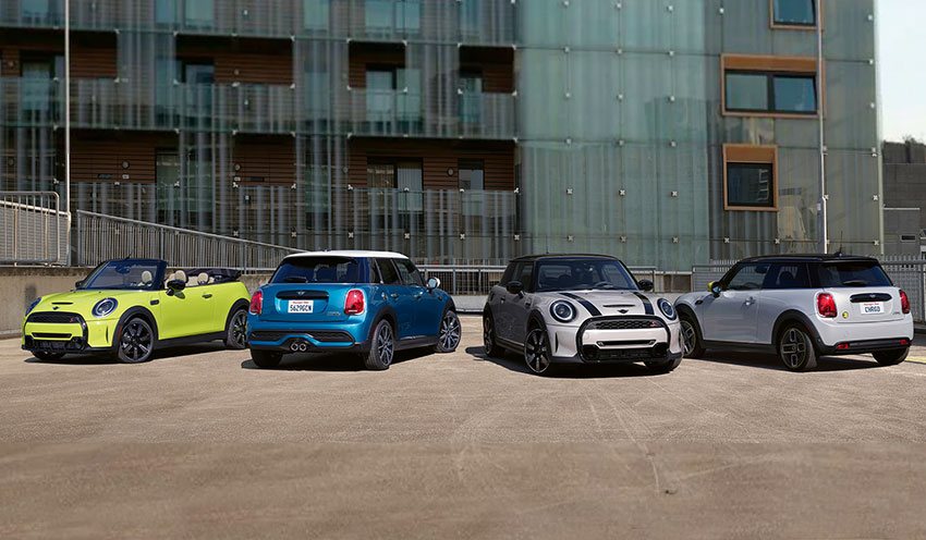 The 2022 MINI Hardtop 2 Door, 2022 MINI Hardtop 4 door, 2022 MINI Hardtop Convertible, and 2022 MINI Electric Hardtop 2 Door parked in a courtyard