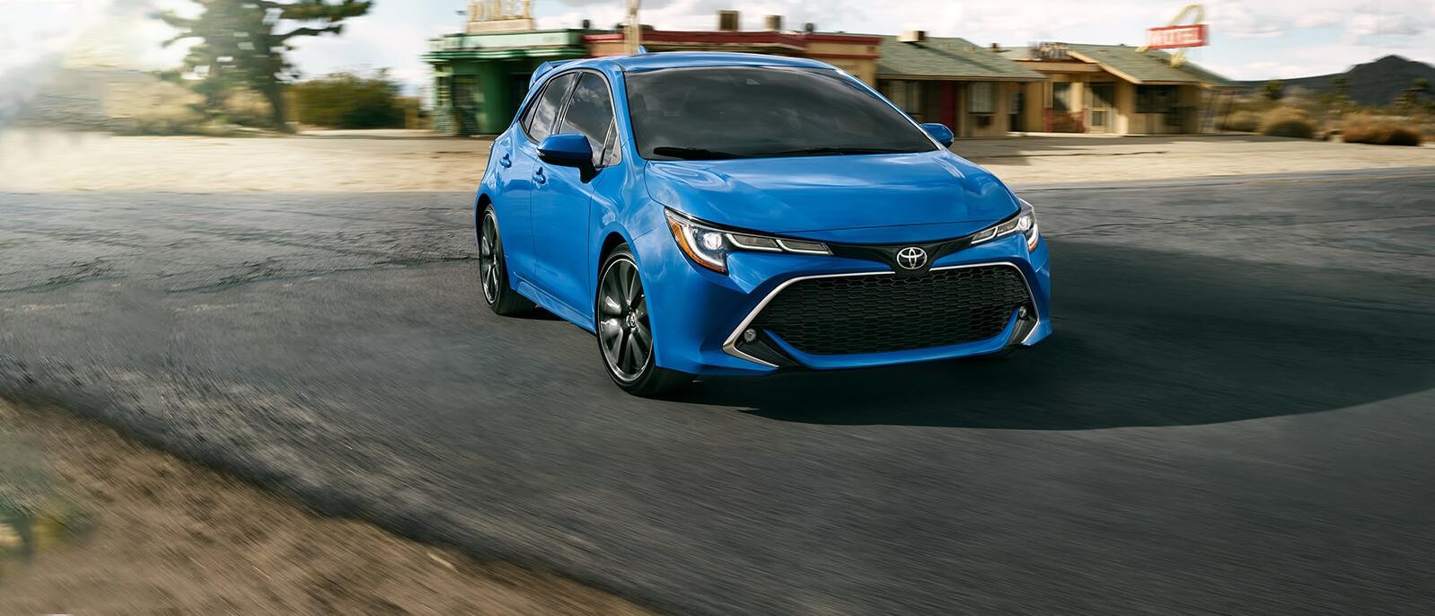 Blue 2020 Toyota Corolla Hatchback cruising on the road