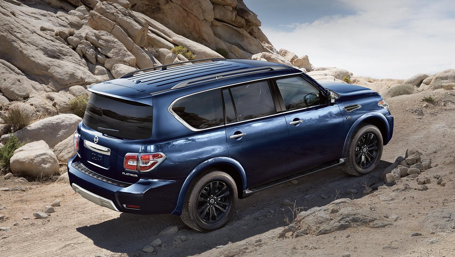 Blue Nissan Armada on the hill.