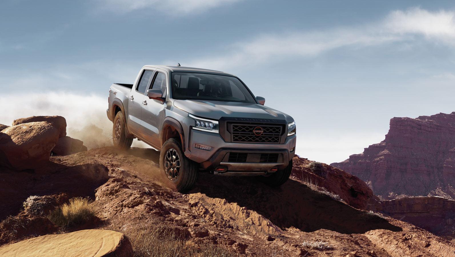 2023 Nissan Frontier is moving on the mountain road.