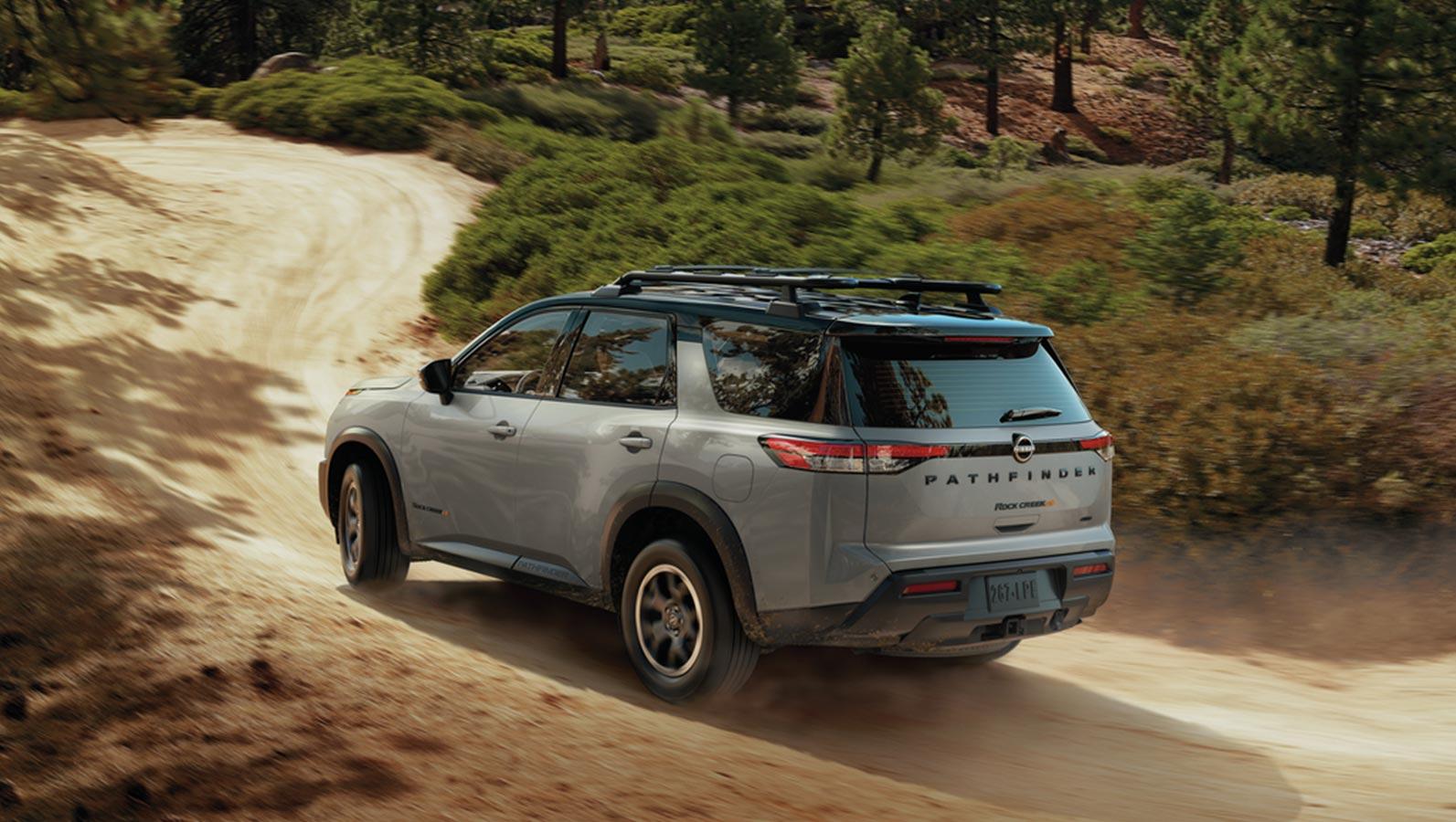 Gray 2023 Nissan Pathfinder cruising on mountain road. Gray 2023 Nissan Pathfinder cruising on mountain road.