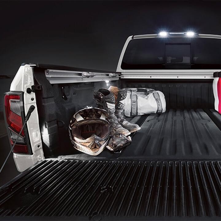 A cargo mat in the back of a white Nissan Titan.