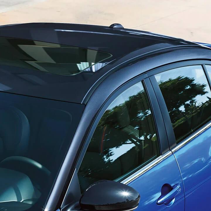 A close-up of a roof rack on a blue Nissan Sentra.