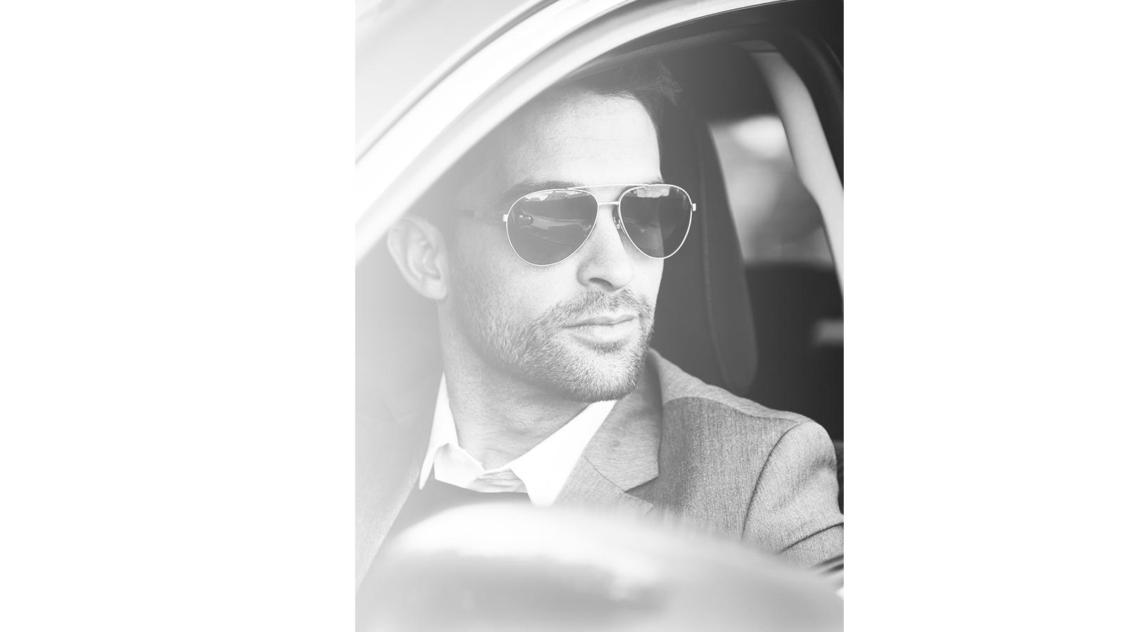 Man with sunglasses driving in a car