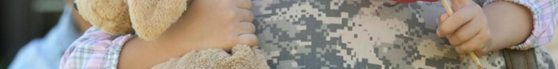 Young girl embracing her military mother