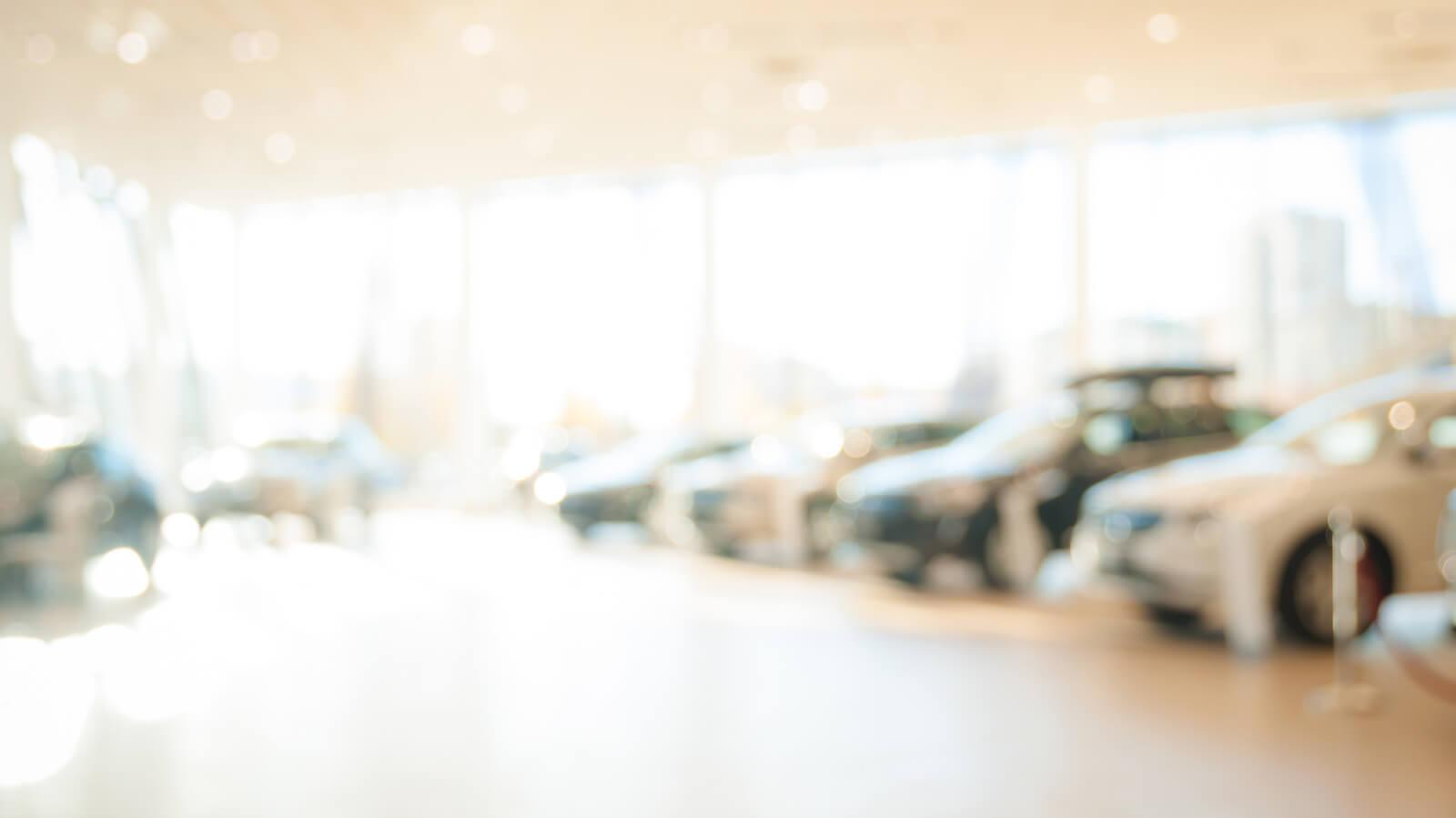 Blurred view of a car dealership showroom