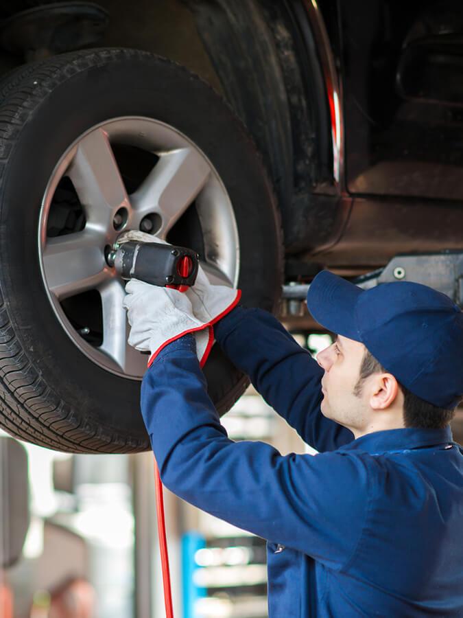 Service mechanic changing a vehicle's tire