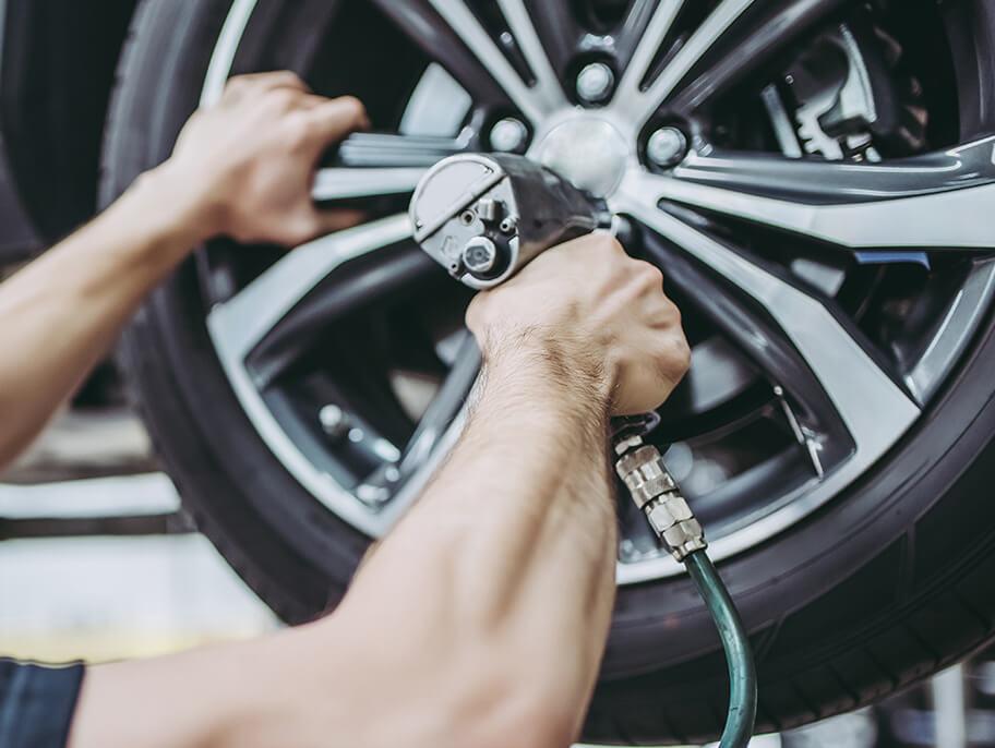 Service mechanic working on a vehicle tire