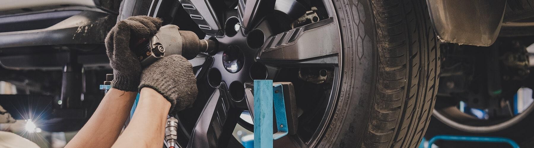 Service mechanic working on a vehicle tire