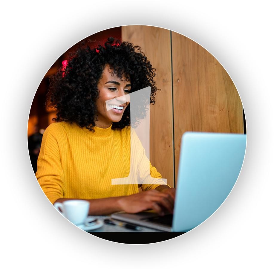 A woman in a yellow shirt on her computer