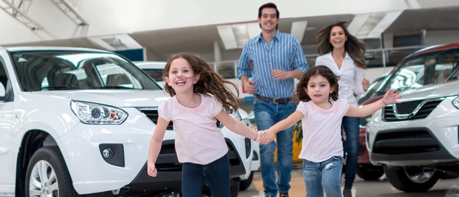 Happy children running in a dealership showroom