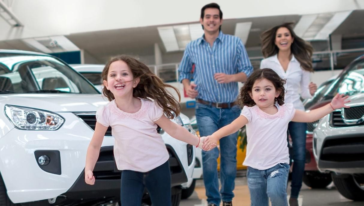 Happy children running in a dealership showroom