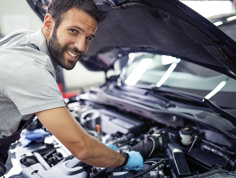 Mechanic working on a vehicle engine