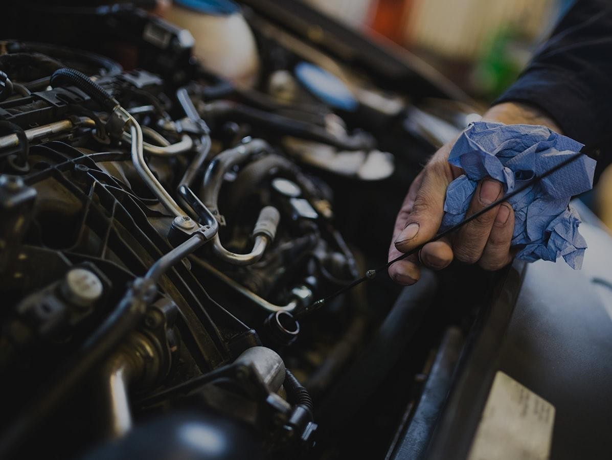 Mechanic checking an engine's oil