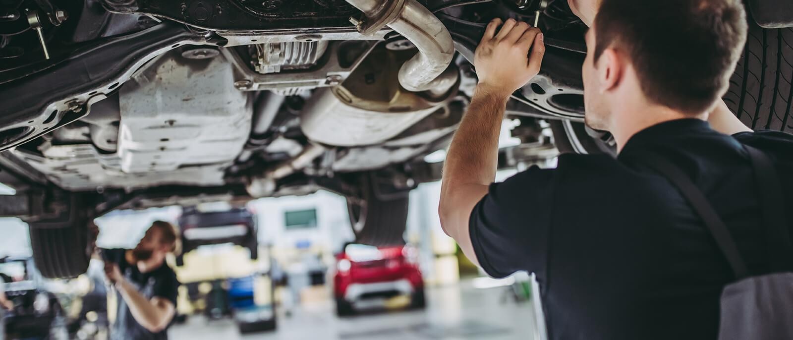 Service mechanics working on a vehicle