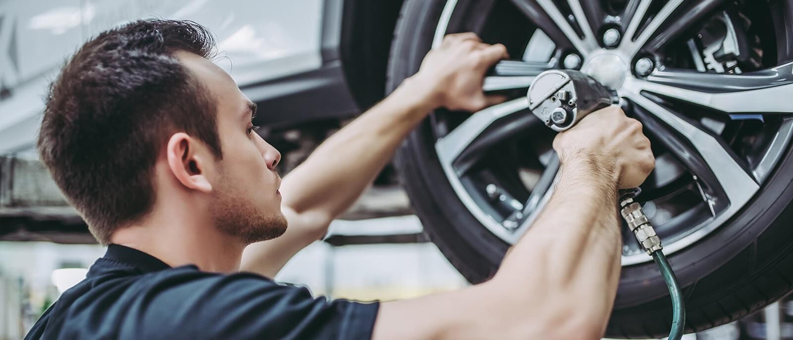 Service mechanic working on a vehicle tire