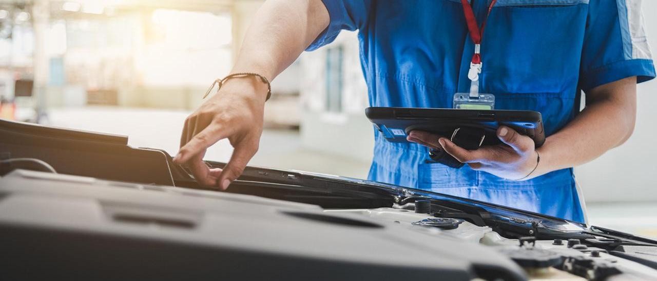 service technician pointing at vehicle