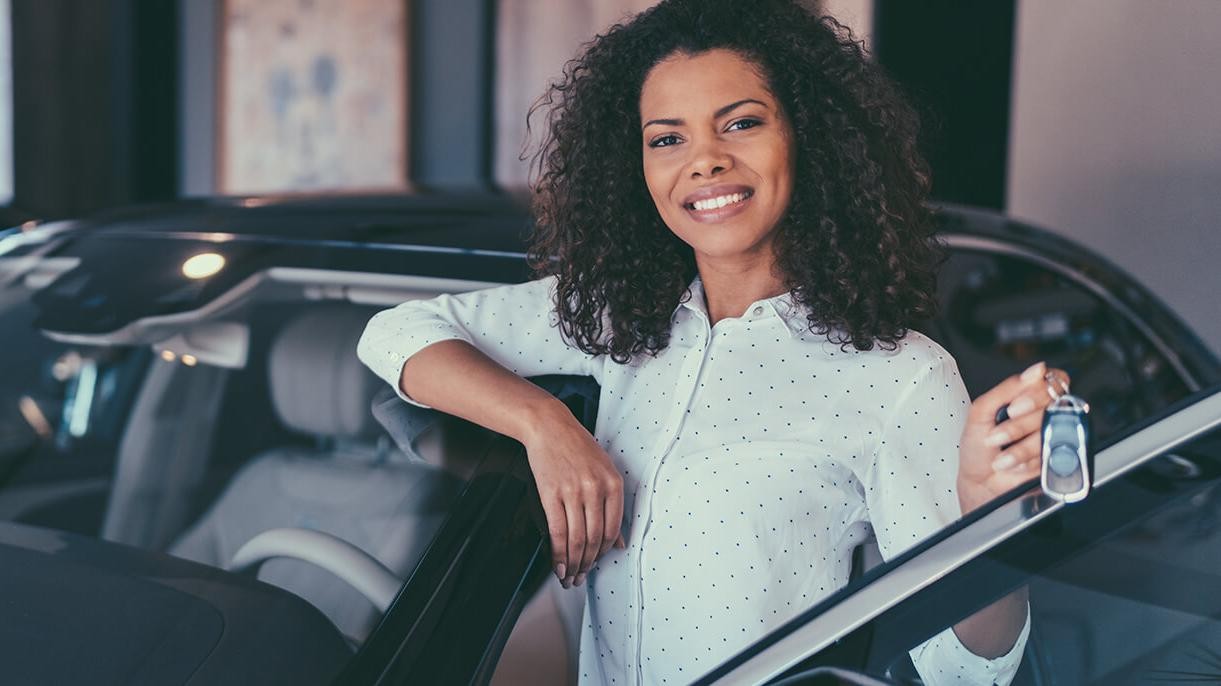 Smiling woman holding new car keys