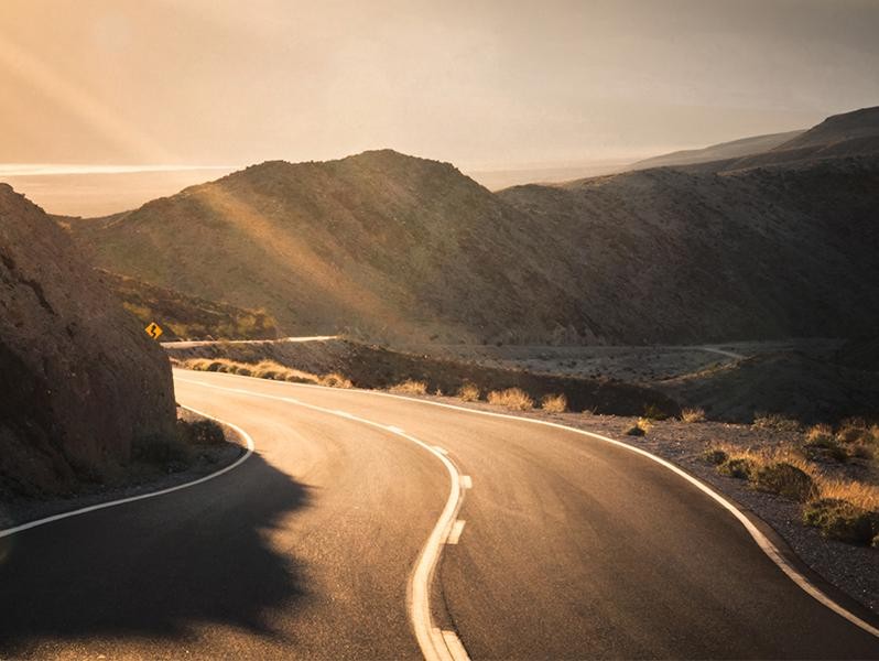 Scenic view from highway travelling at sunset.