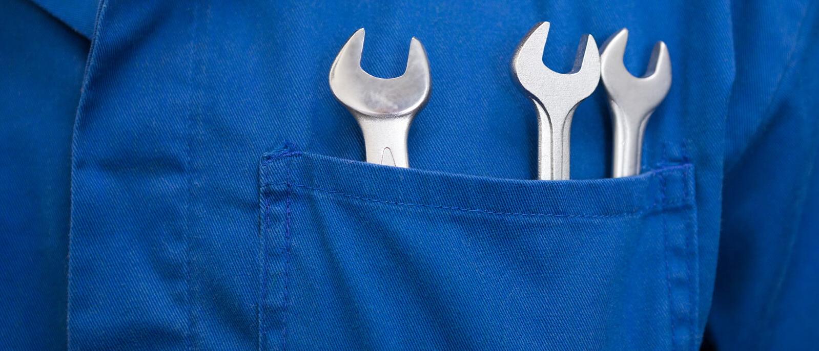 Mechanic's jumpsuit pocket with wrenches in it