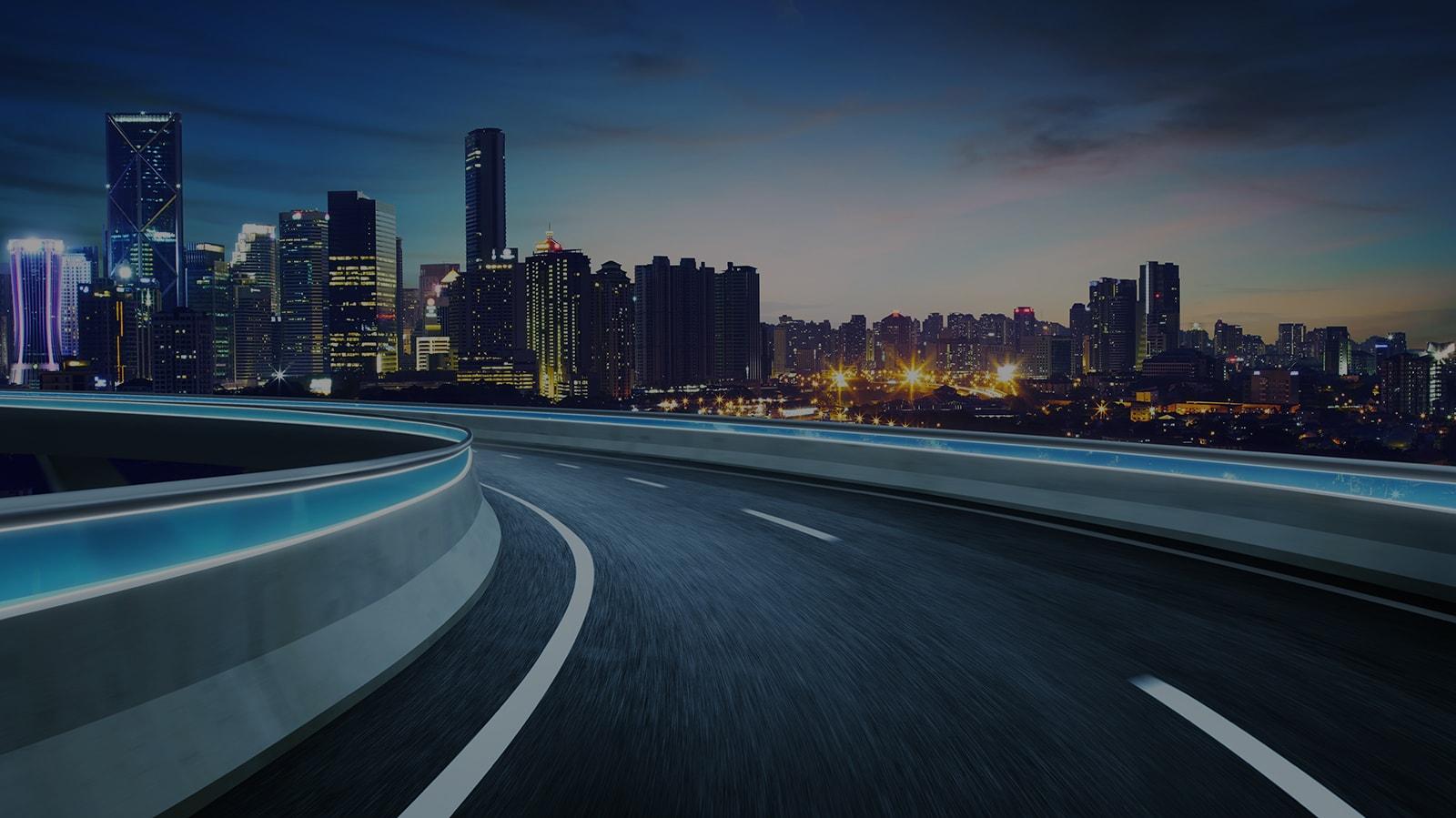 Highway outside a city at night