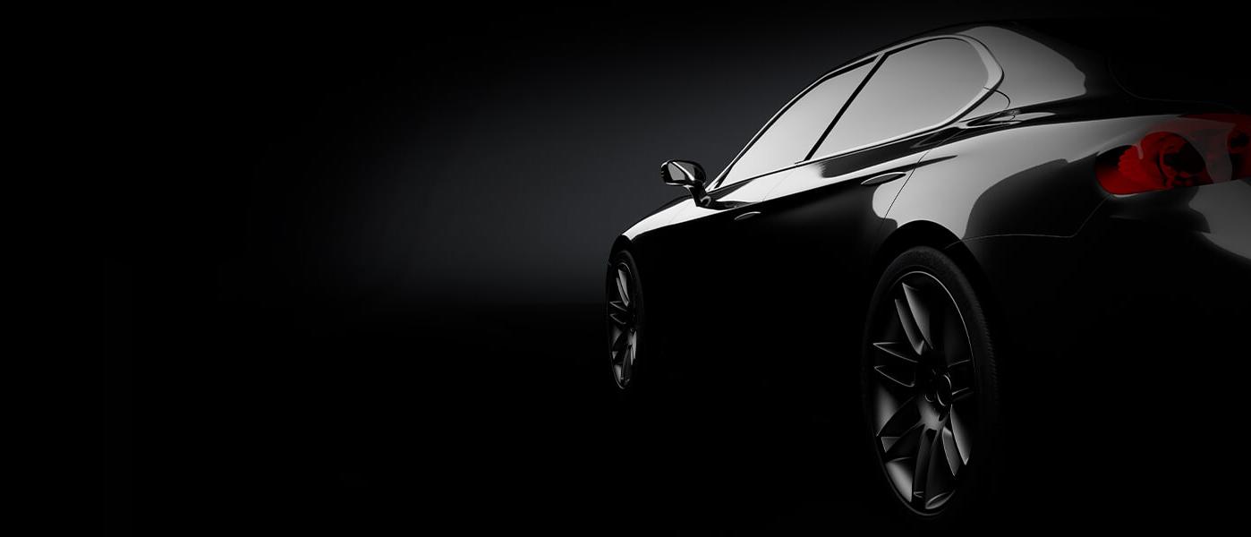 Rear view of a black car on a dark background Rear view of a black car on a dark background