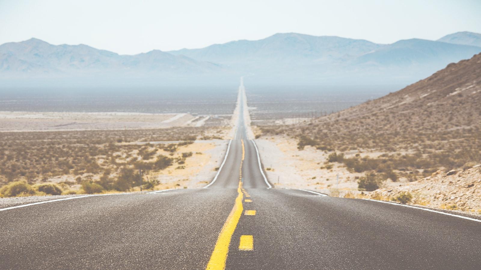 Desert highway leading to the mountains