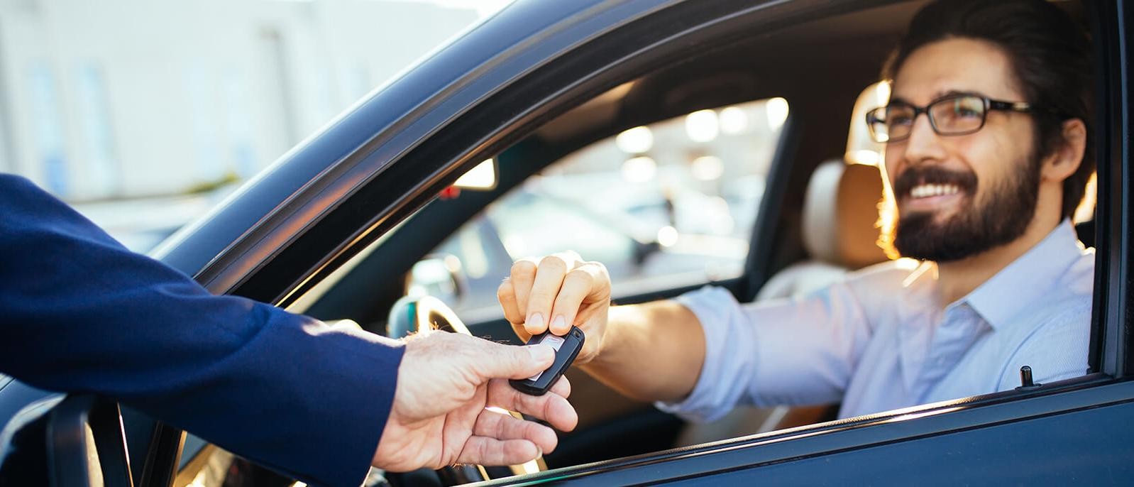 Man taking the keys to his new car